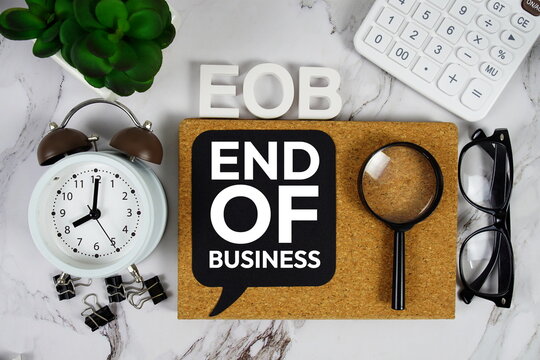 EOB - End of business acronym with calculator, alarm clock and magnifying glass, Business and Financial concept background