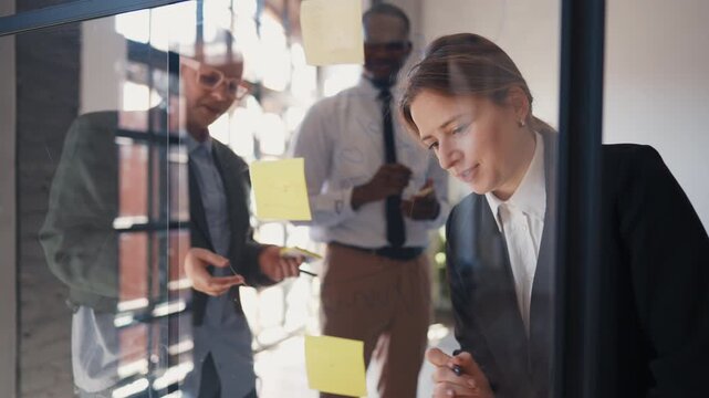 African american and caucasian office workers brainstorming, work on project. Marketing and advertising department, multiethnic people working together in international company, sticky notes on wall