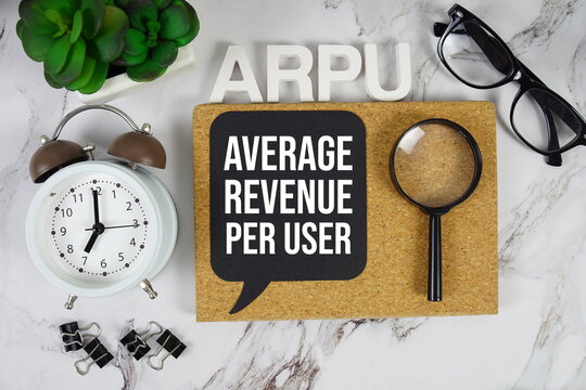 ARPU Average Revenue Per User acronym with alarm clock and magnifying glass, Business concept background
