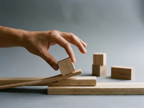 Illustration a hand exerting effort to push a small wooden block uphill