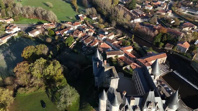 Picturesque aerial establishing shot of the chateau de la rochefoucauld, a historic landmark in charente, france, revealing the magnificent architecture and surrounding medieval village