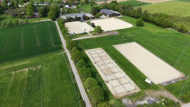 Aerial view of a horse farm with riding arenas and paddocks