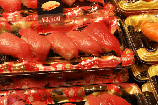 Fresh tuna sushi packs for sale at a Japanese fish market.
