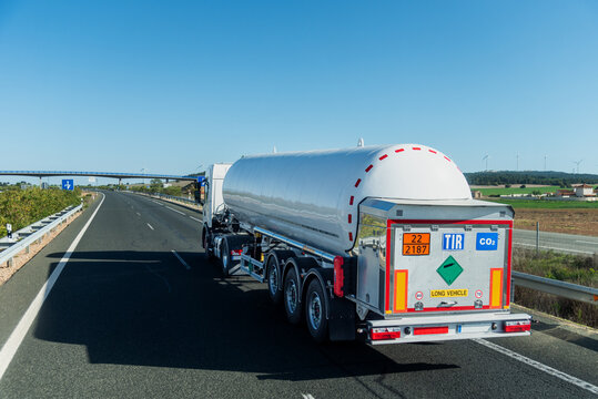 Carbon Dioxide Tanker Truck with Hazard Labels Driving on Highway,TIR transport.