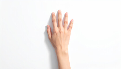 Obraz premium Top-down view of a woman's hand with fingers gently extended on a bright white surface