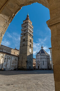 The beautiful Piazza del Duomo in Pistoia, Italy, framed by an arch of the town hall