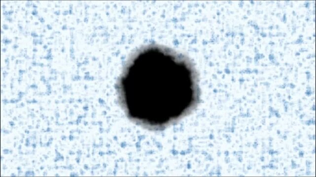 Abstract dark ink blot or stain on a textured light blue background