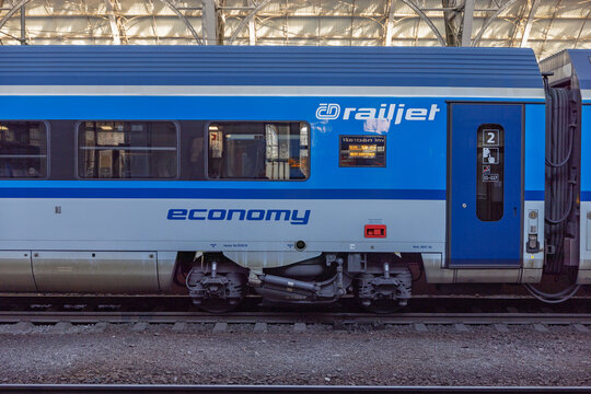 Blue Railjet Economy Train Carriage Parked at Station Platform Side View With Windows and Doors