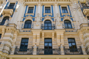 Fototapeta premium Ornate historic european facade with decorative windows and elegant classical architectural details