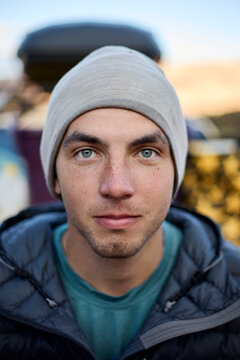 Young man with beanie outdoor portrait looking at camera