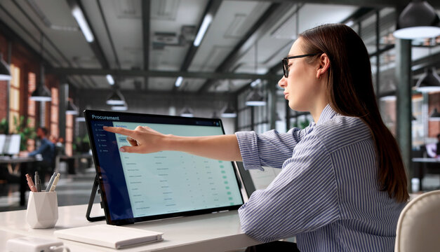 Young Procurement Manager Uses Touchscreen