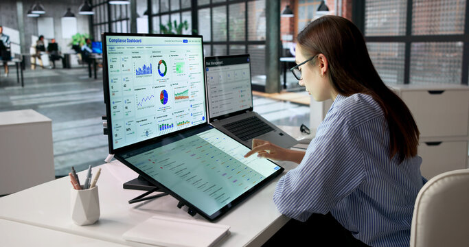 Young Woman Governance Manager Uses Touchscreen Laptop