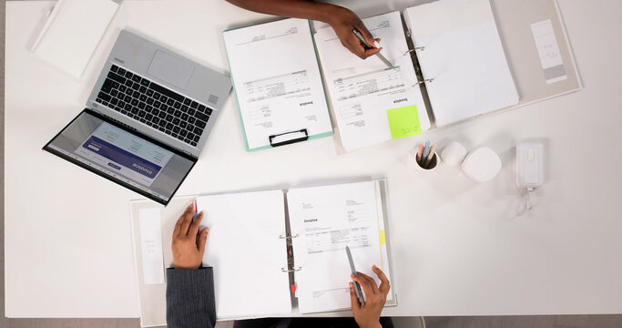 Accountant Carefully Reviewing Invoices