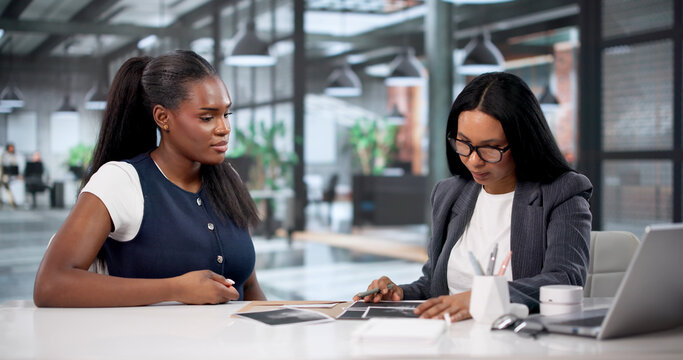 Lawyer Carefully Reviews Contracts And Evidence During Client Meeting