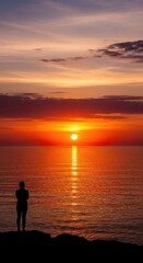 Fototapeta premium Spectacular Sunset Silhouette Over Calm Ocean Waters.