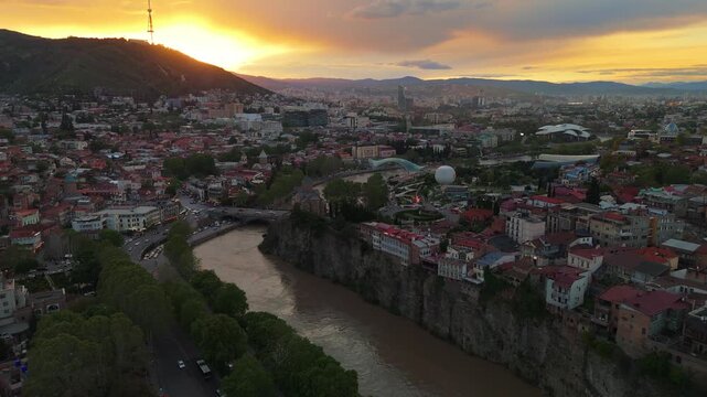 Aerial view of Tbilisi city center featuring the Bridge of Peace, Rike Park, and the Mtkvari River