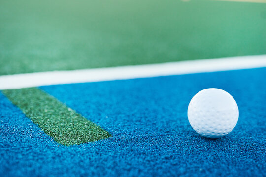 Hockey, closeup and ball with empty pitch for training, outdoor practice and tournament with space. Floor, ground or astro turf with match, game or recreation activity at venue, field or sports club