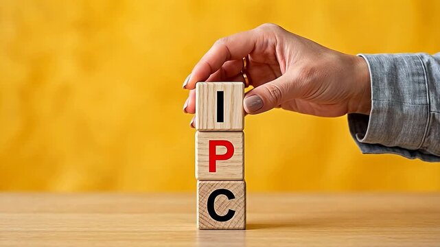 Hand stacking wooden blocks with letters representing futuristic concepts and abstract thought