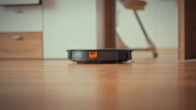 In a modern living room, an autonomous robot vacuum cleaner uses AI-driven sensors to map the floor, methodically cleaning the surface during daylight, demonstrating efficient smart-home technology