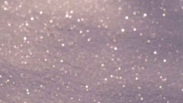 Abstract Glitter Background. Real Snow Blurry Purple Texture Sparkling Shiny Backdrop. Christmas Holiday Banner. Seasonal Wallpaper Decoration. Greeting Wedding Invitation Design. Sparkle Lights Bokeh