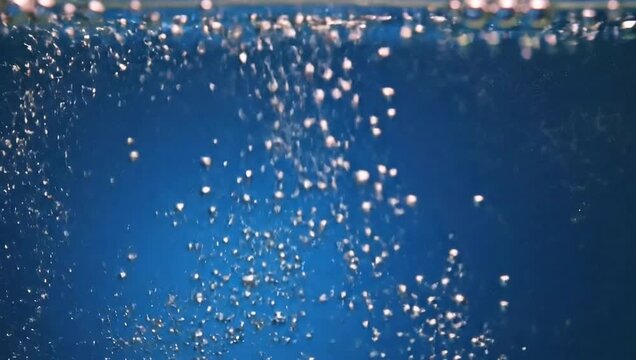 Bubbles Rising in Blue Water - A Captivating Underwater Scene.