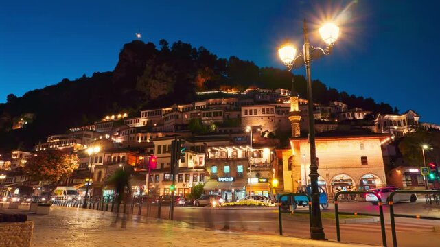 Berat Mangalem night timelapse Albania. UNESCO Ottoman architecture at night with street lamps and traffic light trails. Historic old town atmosphere, Balkan nightlife, heritage.