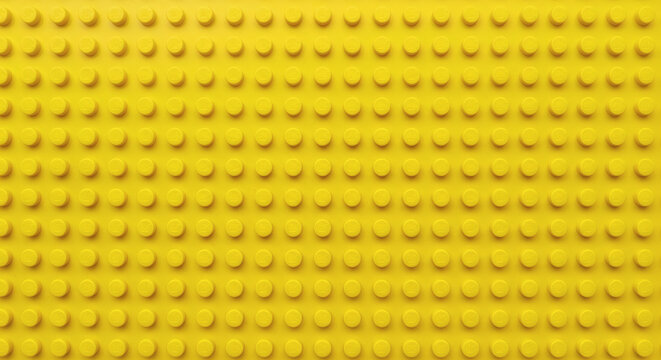 Yellow plastic building block plate texture background for kids toys