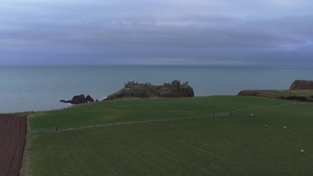 Aerial view of dunnottar castle on coastal cliff in scotland