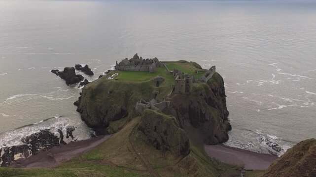 Dramatic aerial view of dunnottar castle ruins on a cliff