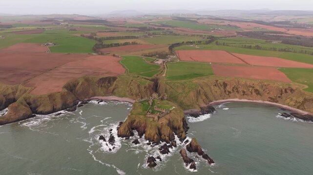 Aerial view of dunnottar castle on rocky promontory in scotland