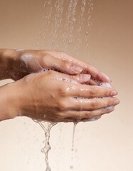 Fototapeta premium studio photography of woman hands with foam on it under the shower water drops.