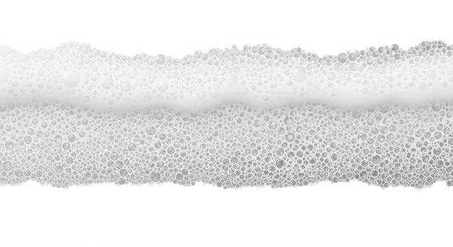 A horizontal strip of white soap foam with numerous small bubbles isolated against a solid black background, view texture
