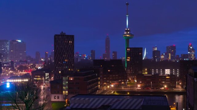 Rotterdam, Netherlands. Aerial view of the city Rotterdam, Netherlands during the night with cloudy sky. Time-lapse at sunrise with car traffic, panning video