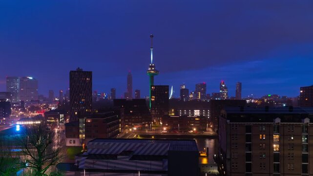 Rotterdam, Netherlands. Aerial view of the city Rotterdam, Netherlands during the night with cloudy sky. Time-lapse at sunrise with car traffic, zoom in