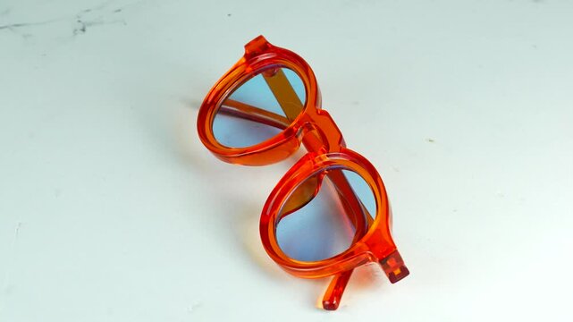 Modern orange transparent glasses rotating 360 degrees on a white background Stylish fashion optical frames Video