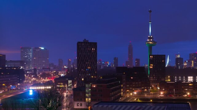 Rotterdam, Netherlands. Aerial view of the city Rotterdam, Netherlands during the night with cloudy sky. Time-lapse at sunrise with car traffic
