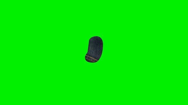 Blue denim fabric comma punctuation mark with yellow stitching on green screen background