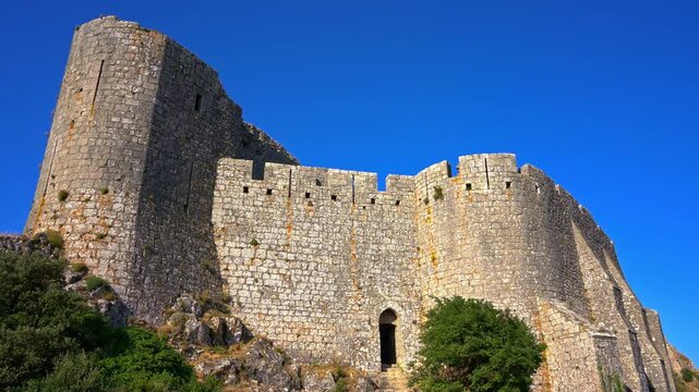Cinematic ground shot of the majestic medieval Cathar castle of Peyrepertuse, historic French fortress ruins and ancient stone architecture site