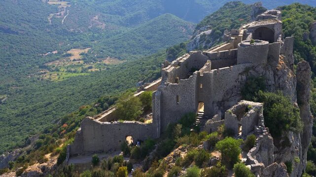 Cinematic ground shot of the majestic medieval Cathar castle of Peyrepertuse, historic French fortress ruins and ancient stone architecture site