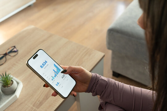 Woman tracking workout activity on smartphone application