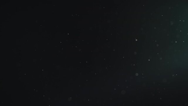 Slow motion real dust particles floating mid air over dark background