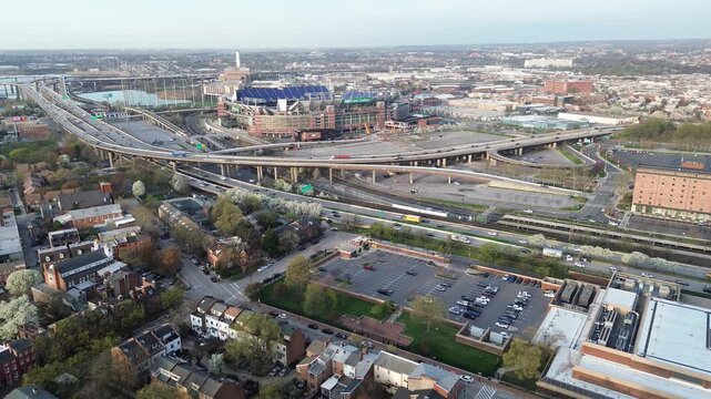 Stadium highway sport complex near Russell St sits beside elevated ramps, parking lots, residential blocks extending downtown. Concrete spans define broad urban textures Baltimore, MD