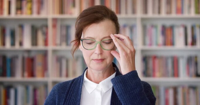 Business, glasses and face of woman in library with knowledge, vision or education for university growth. Professional, confident and professor with eye care for scholarship, research and books