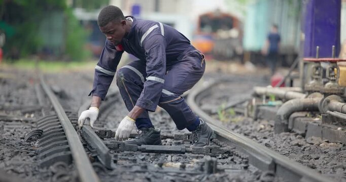Railway Technician Inspects Track Safety in Industrial Rail Yard