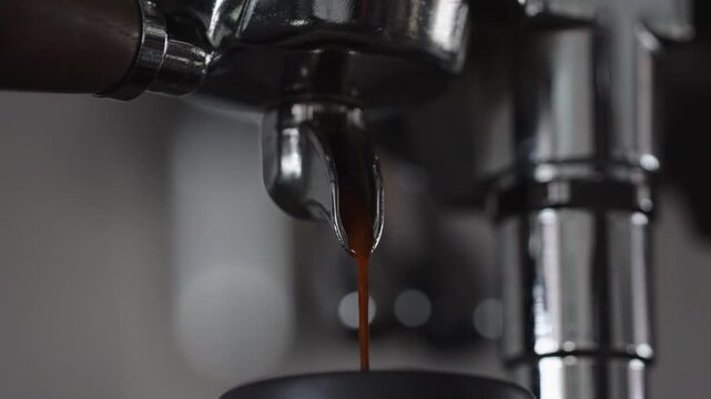 Slow motion espresso pour from single spout portafilter into black cup