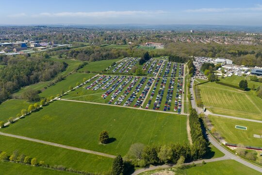 Aerial view of the Harrogate Showground in North Yorkshire England with large parking fields exhibition grounds countryside landscape and suburban development beneath a blue sky with as few clouds