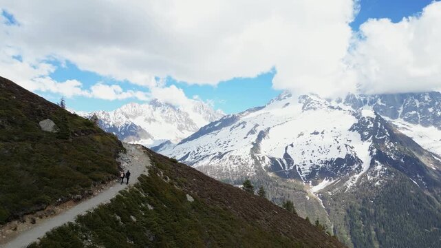 Hikers climbing a snow covered alpine slope near Lac Blanc in Chamonix, France, captured in slow motion