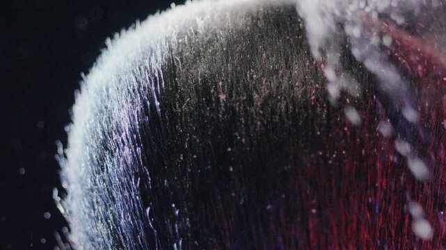 Softly illuminated macro image emphasizing intricate brush textures and particles. Captivating closeup capturing fine dust particles on brush under gentle studio lighting