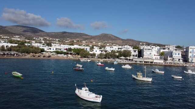 Fishing boats on Aegean Sea port beach, Paros, Drone shot