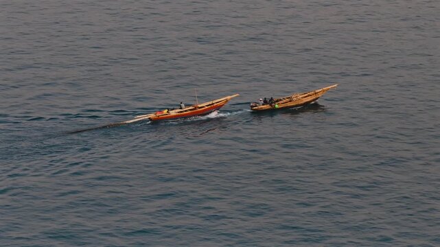 Fisherman on a wooden dhow in Lake Tanganyika, capturing traditional fishing and lakeside life in Tanzania.